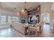 Cozy living room with stone fireplace, wood-look flooring, and plenty of natural light at 8541 E Canyon Estates Cir, Gold Canyon, AZ 85118