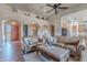 Inviting living room showcasing leather couches, wood-look tile floors, and eye-catching architectural details at 8541 E Canyon Estates Cir, Gold Canyon, AZ 85118