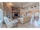 Inviting living room with a stone fireplace, built-in shelving, and comfortable seating at 8541 E Canyon Estates Cir, Gold Canyon, AZ 85118