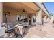 Inviting covered patio features plush seating, a ceiling fan, and stylish stone accents, perfect for outdoor relaxation at 8541 E Canyon Estates Cir, Gold Canyon, AZ 85118