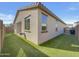 Private backyard with artificial turf and a neutral stucco wall at 9327 E Static Ave, Mesa, AZ 85212