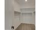 Walk-in closet with ample shelving and clothing rods for organized storage solutions at 9327 E Static Ave, Mesa, AZ 85212