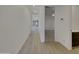 Long hallway featuring light wood flooring and doors to multiple rooms at 9327 E Static Ave, Mesa, AZ 85212