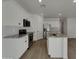 Modern kitchen boasts white cabinetry, stainless steel appliances, and a spacious island with granite countertops at 9327 E Static Ave, Mesa, AZ 85212