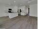 Spacious open-concept living space with stylish tile flooring, seamlessly connecting the kitchen and dining areas at 9327 E Static Ave, Mesa, AZ 85212
