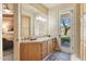 Ensuite bathroom with abundant cabinetry, stone countertops, and access to the outdoors at 9513 N 129Th Pl, Scottsdale, AZ 85259