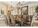 Formal dining room with a large wooden table, elegant chairs, and ornate lighting at 9513 N 129Th Pl, Scottsdale, AZ 85259