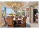 Formal dining area with chandelier and large windows overlooking landscaped backyard at 9513 N 129Th Pl, Scottsdale, AZ 85259