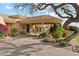 Inviting entrance to this beautiful estate, featuring mature trees, a paver driveway, and lush desert landscaping at 9513 N 129Th Pl, Scottsdale, AZ 85259
