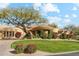 Beautiful residence featuring a lush lawn, desert plants and a circular driveway leading to a covered entry at 9513 N 129Th Pl, Scottsdale, AZ 85259