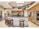 Open kitchen features an island with seating, granite countertops, and stainless steel appliances at 9513 N 129Th Pl, Scottsdale, AZ 85259