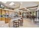 Open kitchen flowing into a living area, showcasing granite countertops and a large island with seating at 9513 N 129Th Pl, Scottsdale, AZ 85259