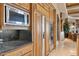 Modern kitchen features stainless steel appliances, a built-in microwave, and stylish wooden cabinetry at 9513 N 129Th Pl, Scottsdale, AZ 85259