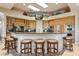Elegant kitchen featuring an island with seating, custom cabinetry, and integrated stainless steel appliances at 9513 N 129Th Pl, Scottsdale, AZ 85259