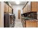 Spacious laundry room with ample storage, granite counters, and modern appliances at 9513 N 129Th Pl, Scottsdale, AZ 85259