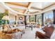 Spacious living room featuring a stone fireplace, coffered ceilings, and comfortable seating at 9513 N 129Th Pl, Scottsdale, AZ 85259
