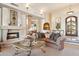 Elegant living room featuring a stone fireplace, comfortable seating, and tasteful decor at 9513 N 129Th Pl, Scottsdale, AZ 85259