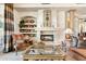 Cozy living room showcasing a stone fireplace, stylish furniture, and warm lighting at 9513 N 129Th Pl, Scottsdale, AZ 85259