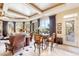 Elegant living room featuring a round table, plush seating, and bright windows with views to the outside at 9513 N 129Th Pl, Scottsdale, AZ 85259