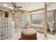 Luxurious main bathroom featuring a soaking tub, glass block accents, and a walk-in shower at 9513 N 129Th Pl, Scottsdale, AZ 85259
