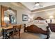 A comfortably designed bedroom with a large framed mirror and traditional style desk at 9513 N 129Th Pl, Scottsdale, AZ 85259