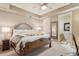 Elegant main bedroom with a decorative headboard, tray ceiling, and ensuite bathroom access at 9513 N 129Th Pl, Scottsdale, AZ 85259