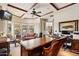 Spacious office with coffered ceilings, a large desk, and comfortable seating area by bright bay windows at 9513 N 129Th Pl, Scottsdale, AZ 85259