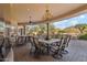 Beautiful outdoor dining on a covered patio featuring desert landscaping and mountain views at 9513 N 129Th Pl, Scottsdale, AZ 85259