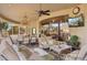 Elegant outdoor living space with chandelier, comfortable seating, and mountain views at 9513 N 129Th Pl, Scottsdale, AZ 85259