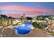 Backyard pool with rock waterfall, lush greenery, and brick surround offering a relaxing outdoor space at 9513 N 129Th Pl, Scottsdale, AZ 85259