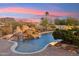 Gorgeous pool features rock waterfall, mature landscaping, and beautiful mountain views for the perfect outdoor escape at 9513 N 129Th Pl, Scottsdale, AZ 85259