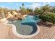 Luxury pool features rock waterfall feature and desert landscaping in the backyard at 9513 N 129Th Pl, Scottsdale, AZ 85259