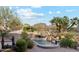 Backyard view showcasing a pool with a rock waterfall feature and desert landscaping at 9513 N 129Th Pl, Scottsdale, AZ 85259