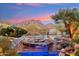 Backyard pool and waterfall feature with desert views in a luxury community at 9513 N 129Th Pl, Scottsdale, AZ 85259
