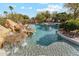 Stunning pool with rock waterfall, lush landscaping, and relaxing spa area at 9513 N 129Th Pl, Scottsdale, AZ 85259