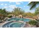 Resort style pool and spa featuring stone accents and desert landscaping at 9513 N 129Th Pl, Scottsdale, AZ 85259