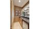 Home wet bar with granite countertop, wood cabinets, and a small fridge for drinks at 9513 N 129Th Pl, Scottsdale, AZ 85259