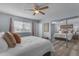 Cozy bedroom with neutral tones, a ceiling fan, and mirrored closet doors that amplify space at 986 Leisure World --, Mesa, AZ 85206