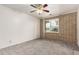 Neutral bedroom with carpet, ceiling fan, and a decorative brick wall at 10009 N 36Th Ave, Phoenix, AZ 85051