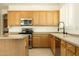 Well-lit kitchen with wood cabinets, stainless steel appliances, and a functional layout at 10127 W Avenida Del Sol --, Peoria, AZ 85383