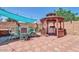 An inviting backyard patio features a gazebo, grill, and outdoor dining set at 10602 N 35Th St, Phoenix, AZ 85028