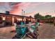 Backyard with outdoor seating, fire pit, and lush landscaping at dusk at 10602 N 35Th St, Phoenix, AZ 85028