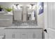 Bathroom featuring dual sinks, a marble countertop, modern mirrors, and decorative elements at 10602 N 35Th St, Phoenix, AZ 85028