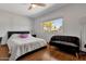 Bright bedroom featuring a comfy bed, a modern ceiling fan, and a window with neighborhood views at 10602 N 35Th St, Phoenix, AZ 85028