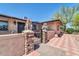Charming entrance gate featuring stone pillars and lion statues on brick paving at 10602 N 35Th St, Phoenix, AZ 85028