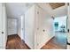Bright hallway with hardwood floors, white walls, and doors leading to other rooms at 10602 N 35Th St, Phoenix, AZ 85028