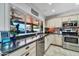 Gourmet kitchen with granite countertops, stainless steel appliances, and a large window overlooking the backyard at 10602 N 35Th St, Phoenix, AZ 85028