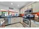 Well-lit kitchen with stainless steel appliances, light-colored cabinetry, and a view of the backyard at 10602 N 35Th St, Phoenix, AZ 85028