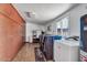 Functional laundry room with ample storage, modern washer/dryer units, and a utility sink at 10602 N 35Th St, Phoenix, AZ 85028