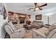 Cozy living room with a stone fireplace, built-in shelves, and comfortable seating, perfect for relaxing at 10602 N 35Th St, Phoenix, AZ 85028